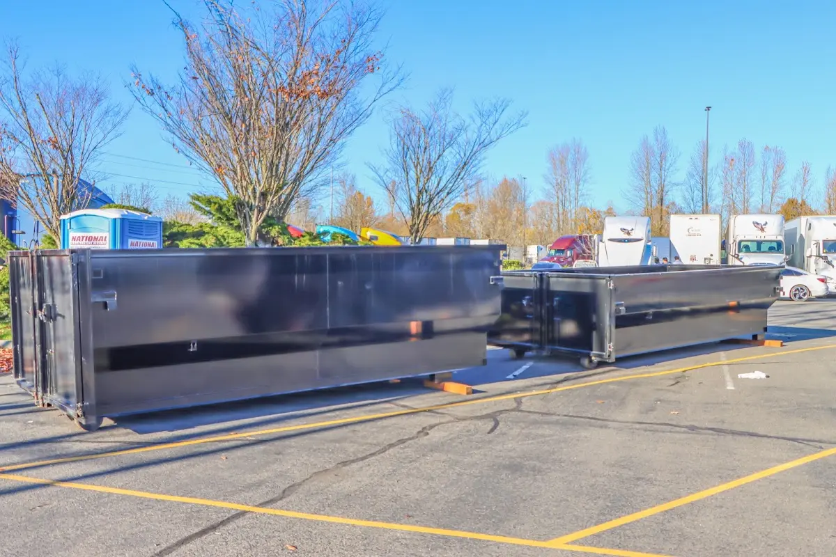 Professional dumpster rental service with roll-off container on residential driveway in Bay Village